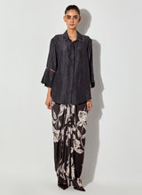 Black Silk Shirt With Embroidered Cuff Details Paired With Draped Maxi Skirt With Embroidered Detailing On Waist.