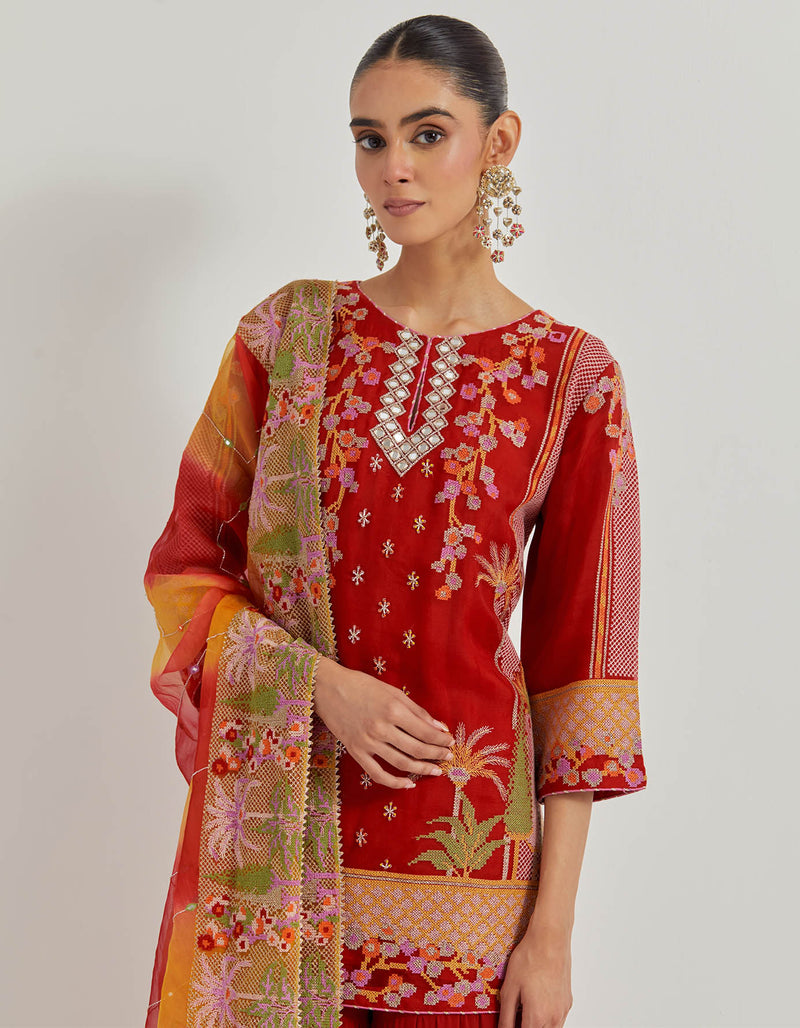 Crimson Red Organza Silk Kurti In Cross Stitch Embroidery Paired With Georgette Tiered Sharara And Organza Dupatta