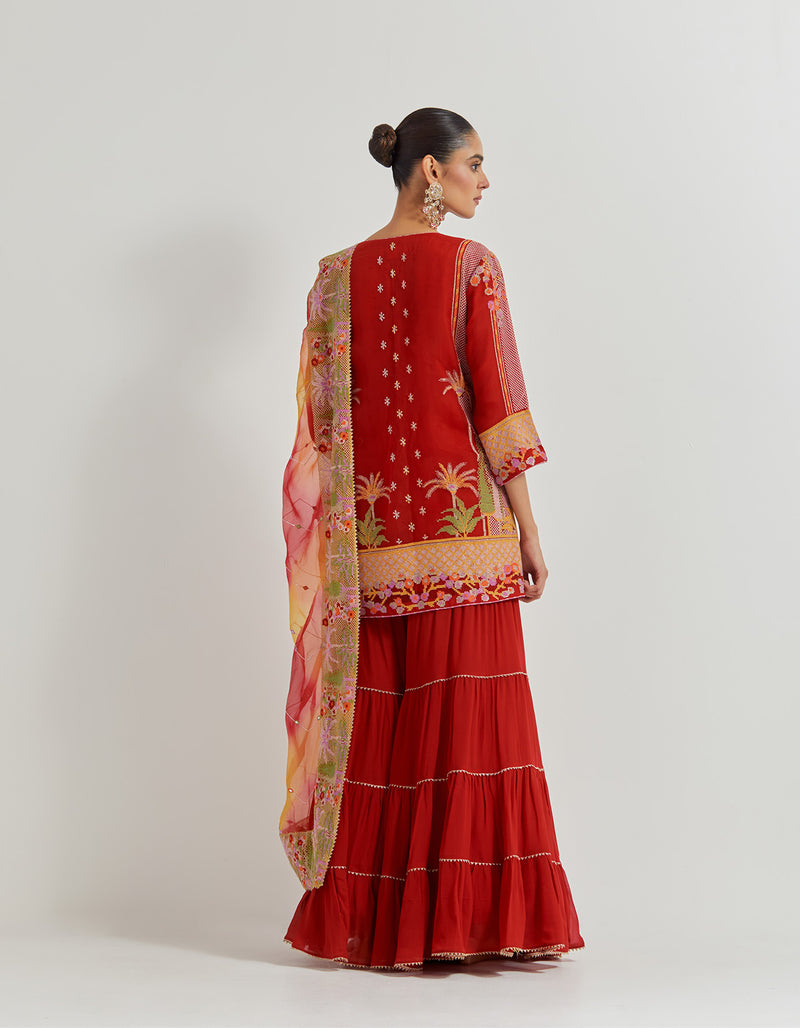 Crimson Red Organza Silk Kurti In Cross Stitch Embroidery Paired With Georgette Tiered Sharara And Organza Dupatta