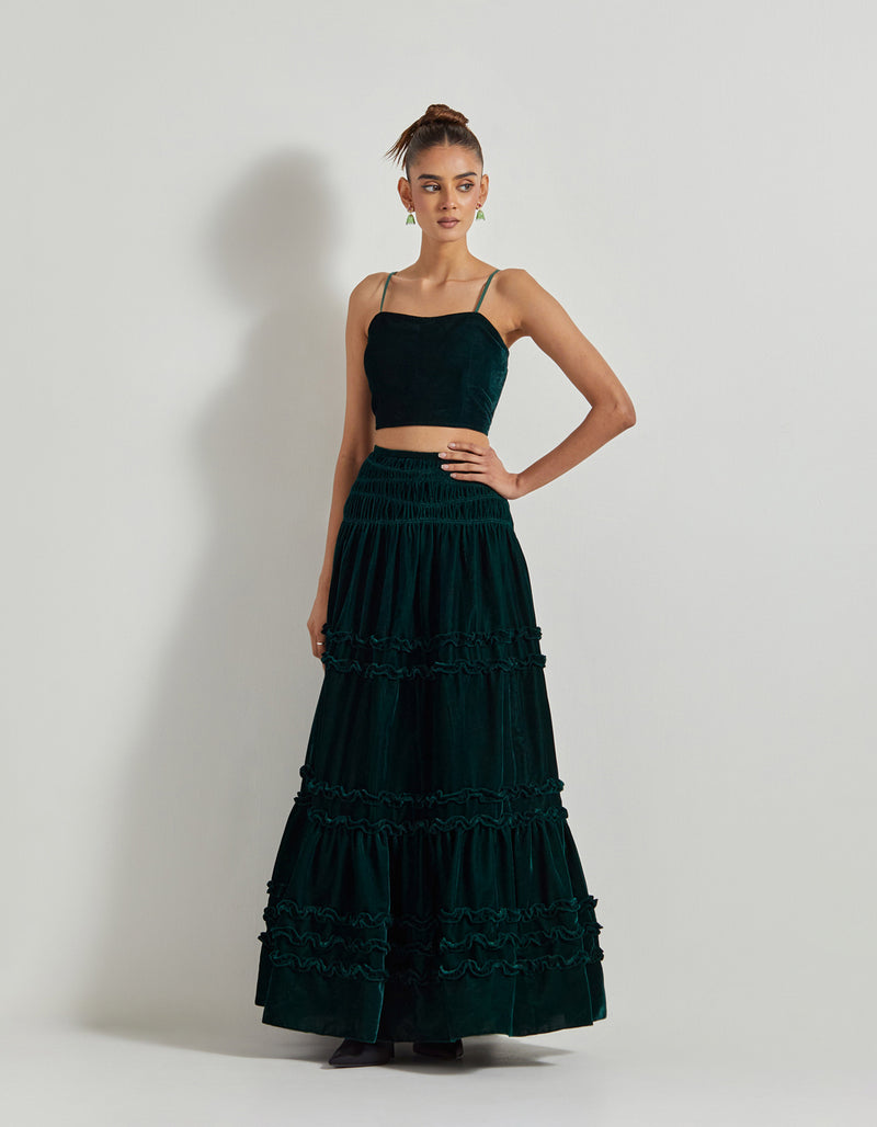 Bottle Green Velveteen Cross Stitch And Hand Embroidred Cape Paired With Pleated Emrboidered Sharara Pants And Bustier