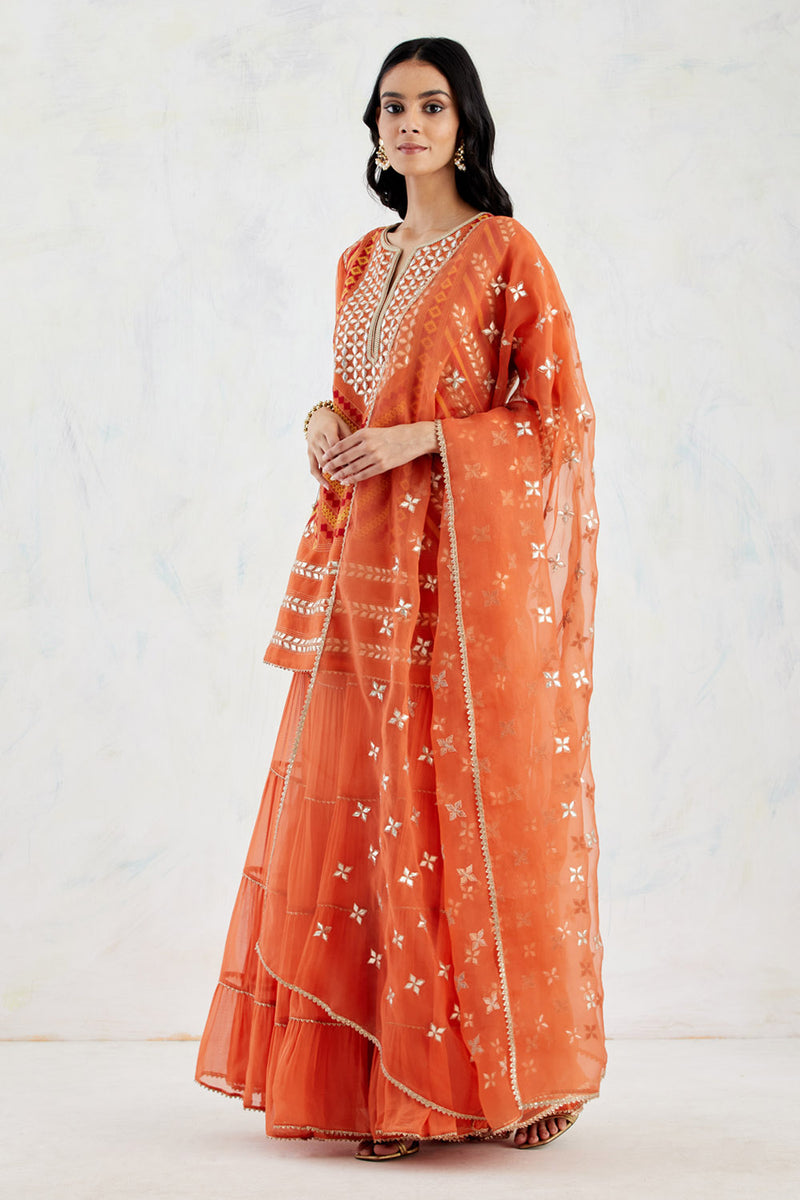 Rust Organza Silk Kurti And Dupatta Paired With Georgette Tiered Sharara In Gota Patti And Cross Stitch Embroidery